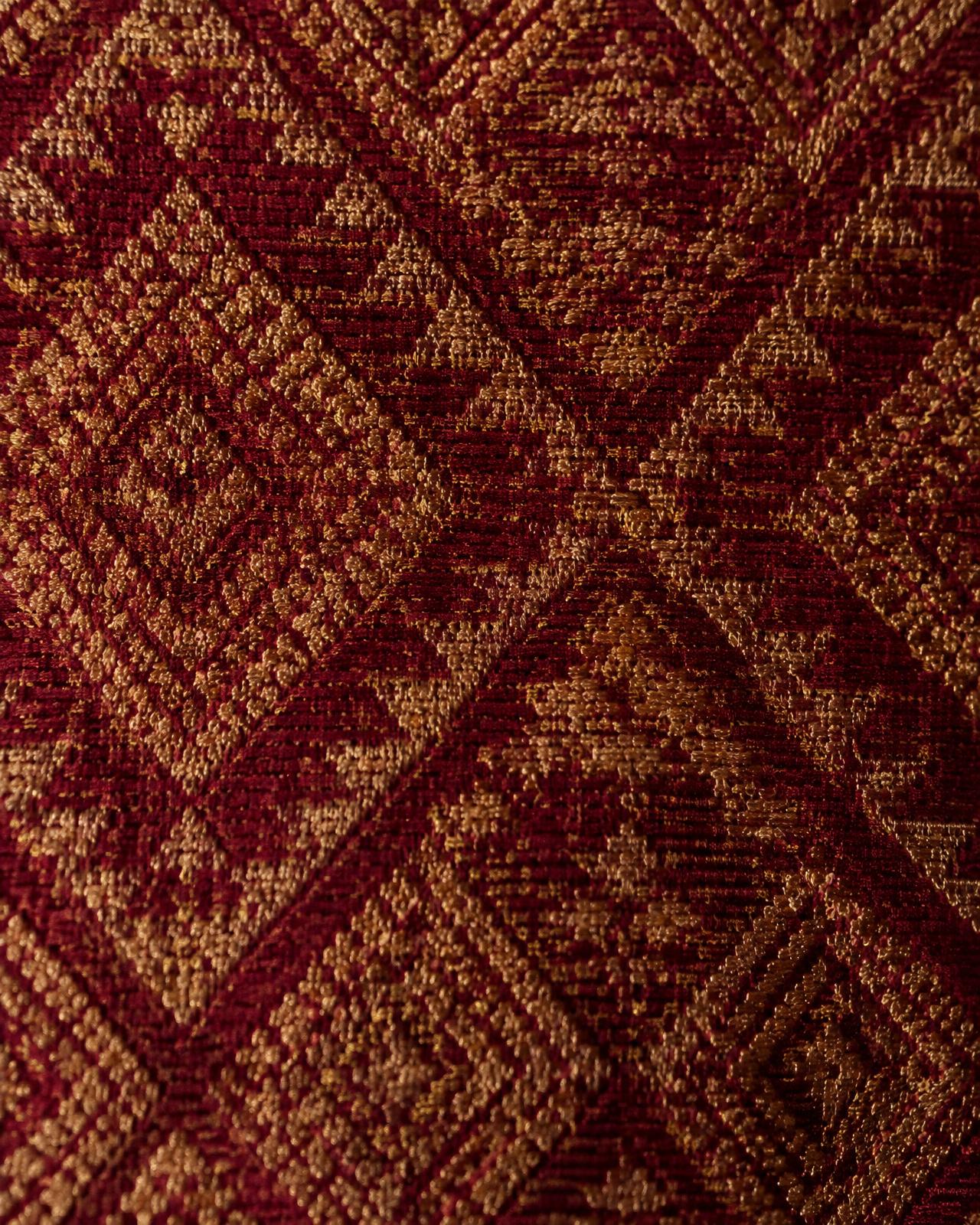 Close-up of maroon and gold woven textile